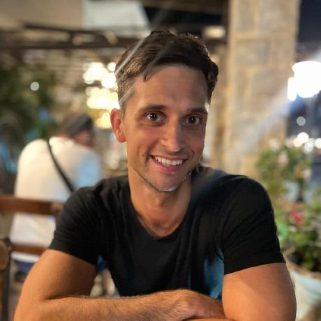 Donatas Daubaras smiling at an outdoor table in the evening